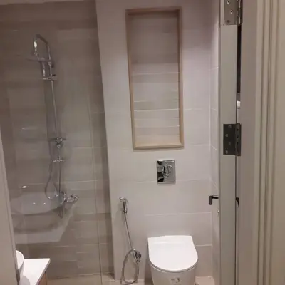 a bathroom with a shower and a toilet and a sink at Exquisite Modern 2-bedroom Rental Unit in Amman