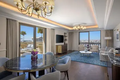 a living room with a dining table and a living room at The Ritz-Carlton, Amman in Amman