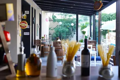a table with bottles of wine on top of it at Aitch Boutique Hotel - an LIH Hotel in Madaba