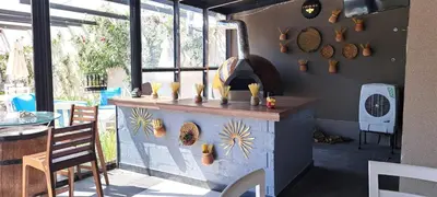 a restaurant with an outdoor oven in a patio at Aitch Boutique Hotel - an LIH Hotel in Madaba