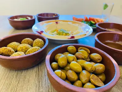 a group of bowls of food on a table at Petra NefNaf Hostel in Wadi Musa