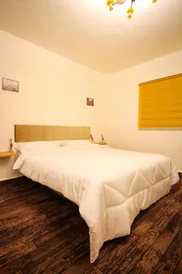 a bedroom with a large white bed in a room at Petra NefNaf Hostel in Wadi Musa