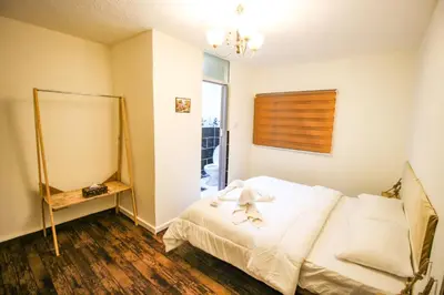 a bedroom with a white bed and a mirror at Petra NefNaf Hostel in Wadi Musa