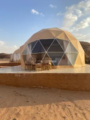 a dome tent in the middle of the desert at Qimam Al Sarab Camp Wadi Rum in Wadi Rum