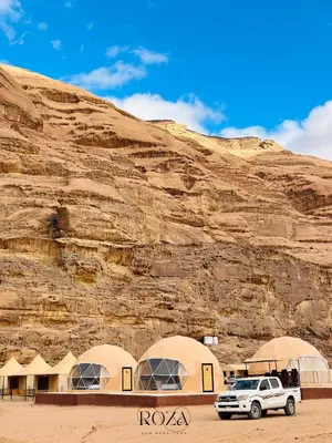 a truck parked in front of a mountain at Rum Four Seasons luxury Camp & Jeep Tours in Wadi Rum