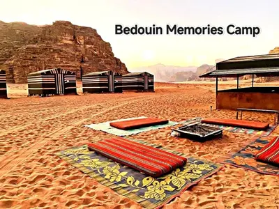 a group of red pillows on the sand in the desert at Bedouin Memories Camp in Wadi Rum