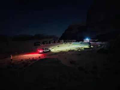 a car parked in a parking lot at night at Bedouin Memories Camp in Wadi Rum