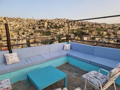 a blue couch sitting on top of a building at Rainbow Guest House in Amman