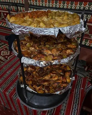 a stack of trays of food on a table at stars magic camp in Wadi Rum