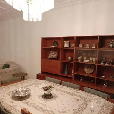 a dining room with a table and a book shelf at Abdoun ground floor apartment in Amman