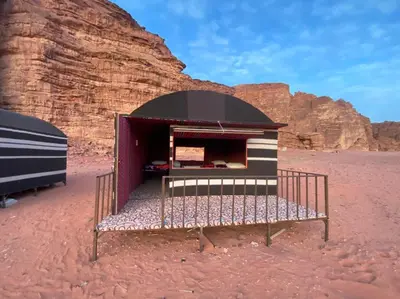 a building in the middle of the desert at Wadi Rum Odyssey Camp in Wadi Rum