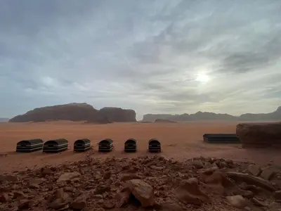 a group of three tents in the desert at Wadi Rum Odyssey Camp in Wadi Rum