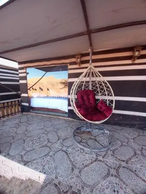 a room with a hanging hammock on a roof at falling Stars Camp in Wadi Rum