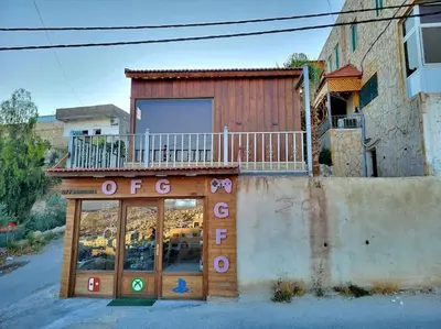 a store front with a balcony on top of it at atoom lodge in Jerash