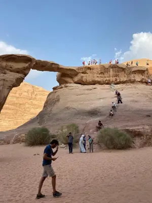 a group of people walking in the desert at Sandy Camp Wadi Rum in Wadi Rum