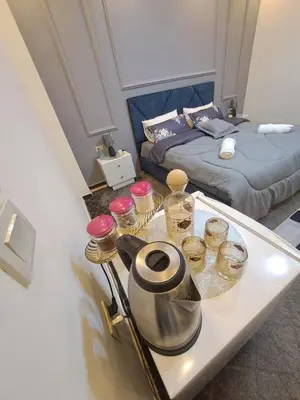 a room with a tray with jars and a bed at Hadrian's Arch in Jerash