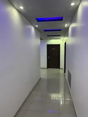 a hallway with a blue light on the ceiling at Shihan hotel suites in Amman