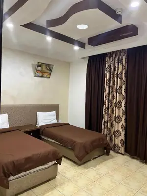 a hotel room with two beds and a window at Shihan hotel suites in Amman