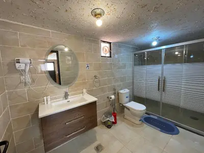 a bathroom with a sink and a toilet and a mirror at Rum Magic Nights in Wadi Rum