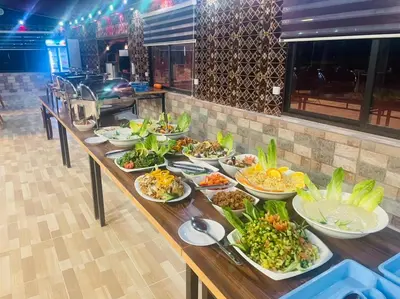a buffet with many plates of food on a table at Rum Magic Nights in Wadi Rum