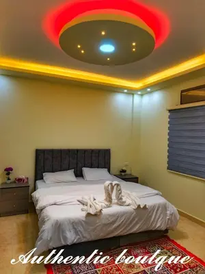 a bedroom with a large bed with a red ceiling at Authentic boutique in Wadi Musa