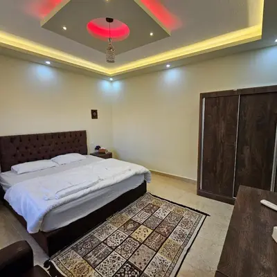 a bedroom with a bed and a red ceiling at Authentic boutique in Wadi Musa