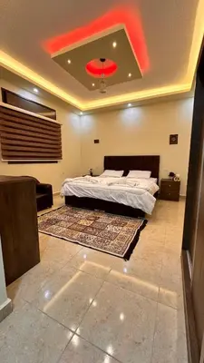 a bedroom with a bed and a red ceiling at Authentic boutique in Wadi Musa