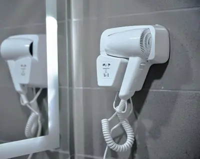 a phone hanging on a wall in a bathroom at Beit Alshabaan Inn in Wadi Musa