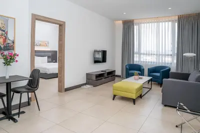 a living room with a couch and a table at Liv Weibdeh Hotel Suites in Amman