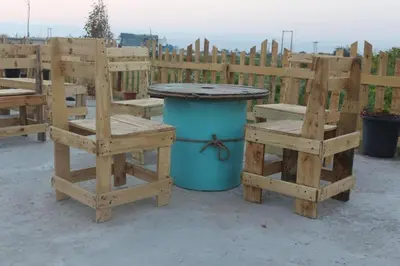 a table and two benches and a trash can at Safi Kitchen Hostel in Aş Şāfī