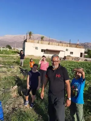 a group of people standing in front of a house at Safi Kitchen Hostel in Aş Şāfī