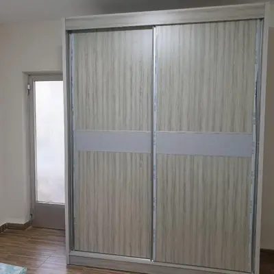 a sliding glass door in a room with a window at شقة مفروشة في ام اذينة in Amman