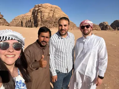 a group of four people standing in the desert at Wadi Rum Magic Camp in Wadi Rum