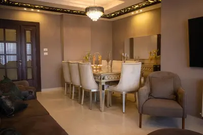 a dining room with a table and chairs at Alghalayieny Modern Apartments in Amman