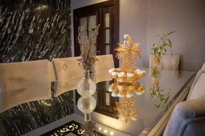 a glass table with two vases on top of it at Alghalayieny Modern Apartments in Amman