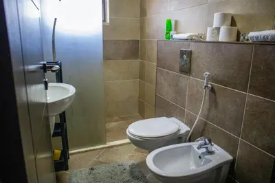 a bathroom with a toilet and a sink at Alghalayieny Modern Apartments in Amman