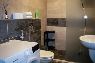 a bathroom with a toilet and a sink at Alghalayieny Modern Apartments in Amman