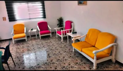 a waiting room with chairs and tables and a window at Jerash -HeritageHotel in Jerash