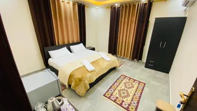 a bedroom with a large bed with white pillows at Petra Olive House in Wadi Musa