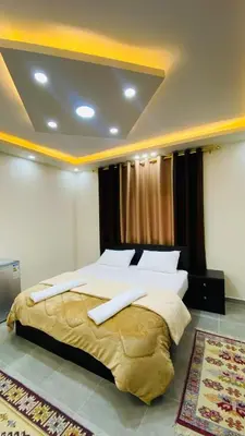 a bedroom with a large bed with two white pillows at Petra Olive House in Wadi Musa