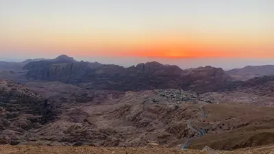a view of the mountains with the sun setting at Petra Olive House in Wadi Musa