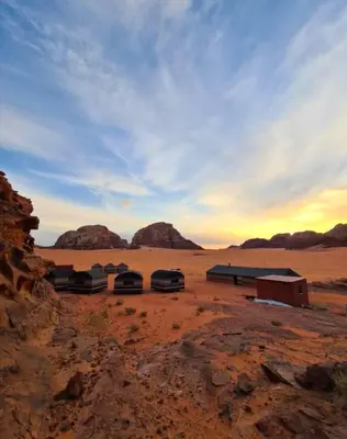 a group of huts in the middle of the desert at Wadi Rum Local Guide in Wadi Rum