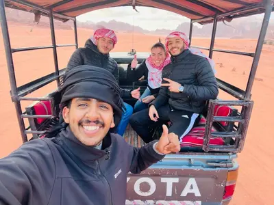 a man giving a thumbs up while riding in a cable car at Wadi Rum Local Guide in Wadi Rum