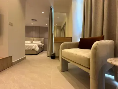 a bedroom with a bed and a couch and a chair at Damac Tower Amman - Luxury Studio - استوديوهات فاخرة - داماك عمان العبدلي in Amman