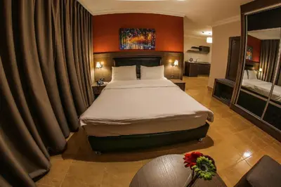 a bedroom with a large bed in a hotel room at Ibiza Hotel in Amman