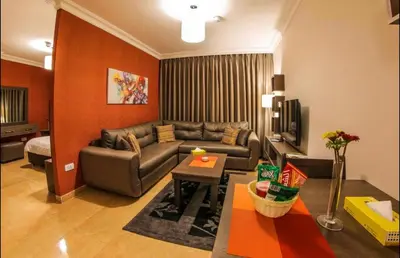 a living room with a couch and a table at Ibiza Hotel in Amman