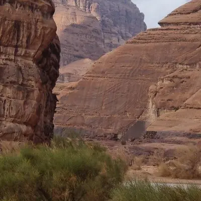 a view of a canyon with a steep cliff at The sun of Wadi Rum in Wadi Rum