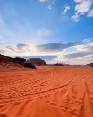 a desert with a blue sky and some rocks at The sun of Wadi Rum in Wadi Rum