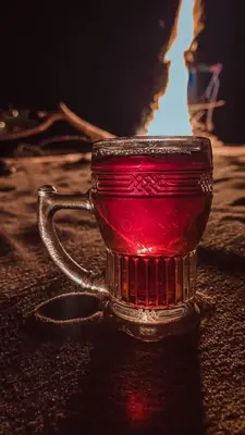 a red glass cup sitting on a table at Adam Bedouin camp in Wadi Rum