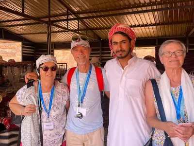 a group of people are posing for a picture at Wadi Rum Star Camp in Wadi Rum